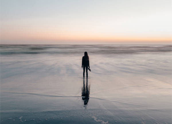 woman on beach at sunset